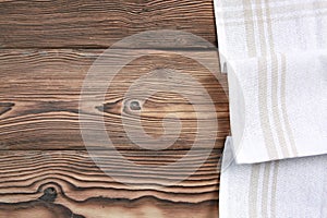 White towel cloth on dark wooden table top background empty space,food advertisemnt backdrop
