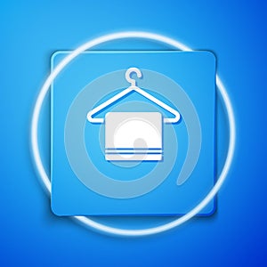 White Towel on a hanger icon isolated on blue background. Bathroom towel icon. Blue square button. Vector Illustration