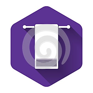 White Towel on a hanger icon isolated with long shadow. Bathroom towel icon. Purple hexagon button