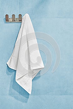 White towel hanging on a wall in bathroom