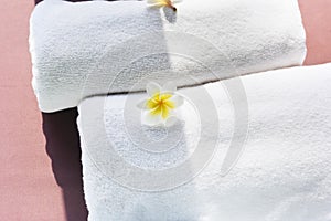 White towels decorated with plumeria flowers