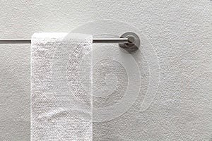 White towels hang on stainless steel rails in the bathroom