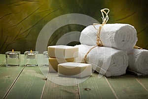 White towels, soap and candle