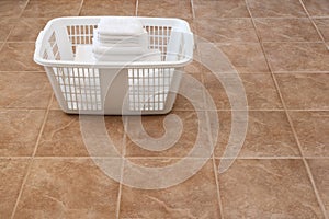 White towels stacked in a laundry basket