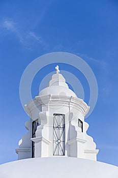 White tower with catholic cross on top in the roof of the Cathedral in Leon city, Nicaragua