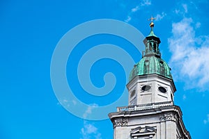 White tower,green roof,gold cross on top