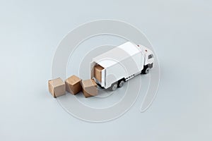 White toy truck with boxes on a light background, space for text.