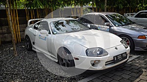 White Toyota Supra A80 Turbo MK IV parked and displayed in JDM run car meet