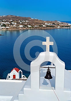 White traditional greek church on the background of the Mediterranean Sea