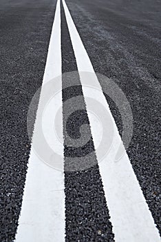 White traffic lines marking on asphalt road
