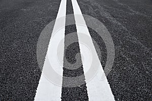 White traffic lines marking on asphalt road