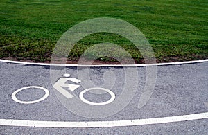 White traffic sign, bicycle lane symbol on curve asphalt road