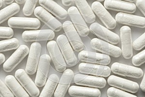 White Transparent Capsules or Tablets on the White Background. M