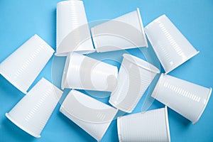 White transparent disposable plastic cups on the blue background