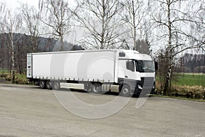 White transport truck in open space with copy space for text european trailer tractor for shipping goods on roads