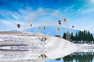 White travertine terrace formations, pool with clear hot water from thermal springs in Pamukkale, Denizli Province in southwestern