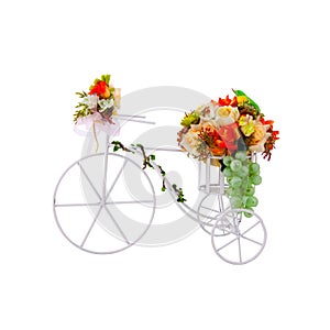 White tricycle decorate with fabric flowers on white background