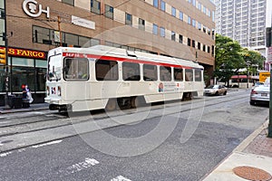 A white trolly seen on a Philadelphia city street