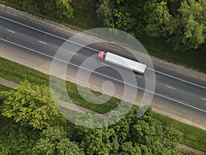 White Truck with Cargo Semi Trailer Moving on Summer Road. Aerial Top View