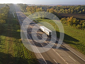 White Truck with Cargo Semi Trailer Moving on Summer Road. Aerial Top View