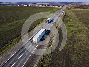 White Truck with Cargo Semi Trailer Moving on Summer Road. Aerial Top View