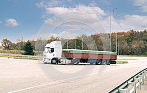 White truck with cargo on the turn on the track