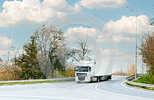 White truck with cargo on the turn on the track