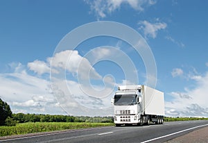 White truck on country highway under blue sky