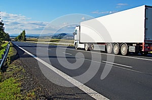 White truck driving on the road a rural landscape