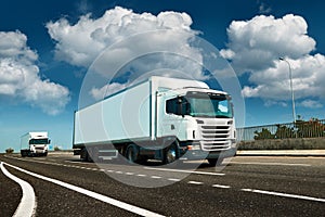 White truck is on highway - business, commercial, cargo transportation concept, clear and blank space on the side view