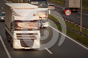 White truck in motion blur and bus on highway