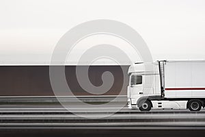 White truck moving on a highway. Truck panning. Selective focus