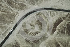 A white truck runs on the pan-American Highway through Nazca desert in Peru.