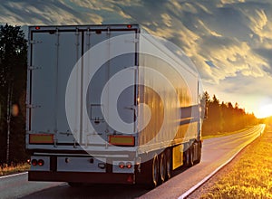 White truck on rural road in evening