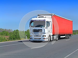 White truck tractor semitrailer with red awning