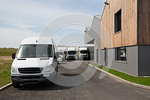 White truck and van in industrial environment near factory delivery distribution warehouse