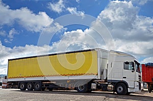 White truck and yellow trailer