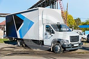 White trucker in the parking lot are waiting for the next delivery of goods. The concept of a transport company for the delivery