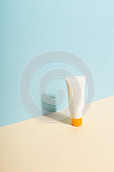 White tube of sunscreen on  blue background. Sun Protection. Copy space