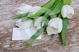 White tulips bouquet and blank greeting card