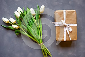 White tulips bouquet and postcard on grey background