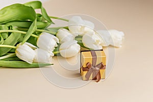 White Tulips and Elegant Gift Box on Neutral Backdrop