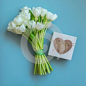 White tulips and gift box on background. Spring concept.