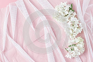 White tulle and beautiful hydrangea flowers. pink table background. feminine wedding, birthday floral concept. top view, copy