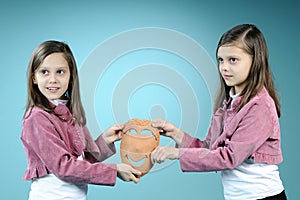 White twin sisters showing handmade masque photo