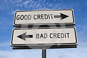 White two street signs with arrow on metal pole with word good credit and bad credit