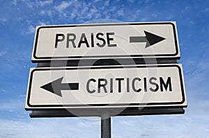 White two street signs with arrow on metal pole with word Praise and Criticism