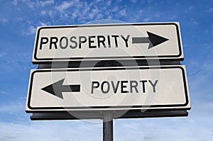 White two street signs with arrow on metal pole with word prosperity and poverty