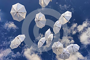 White umbrellas in the blue sky
