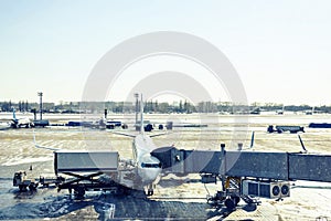 White unbranded plane boarding on gate